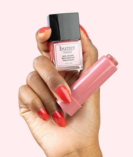 Blush Crush: Hand holding Nail Blush and Silky Tint against pale pink background