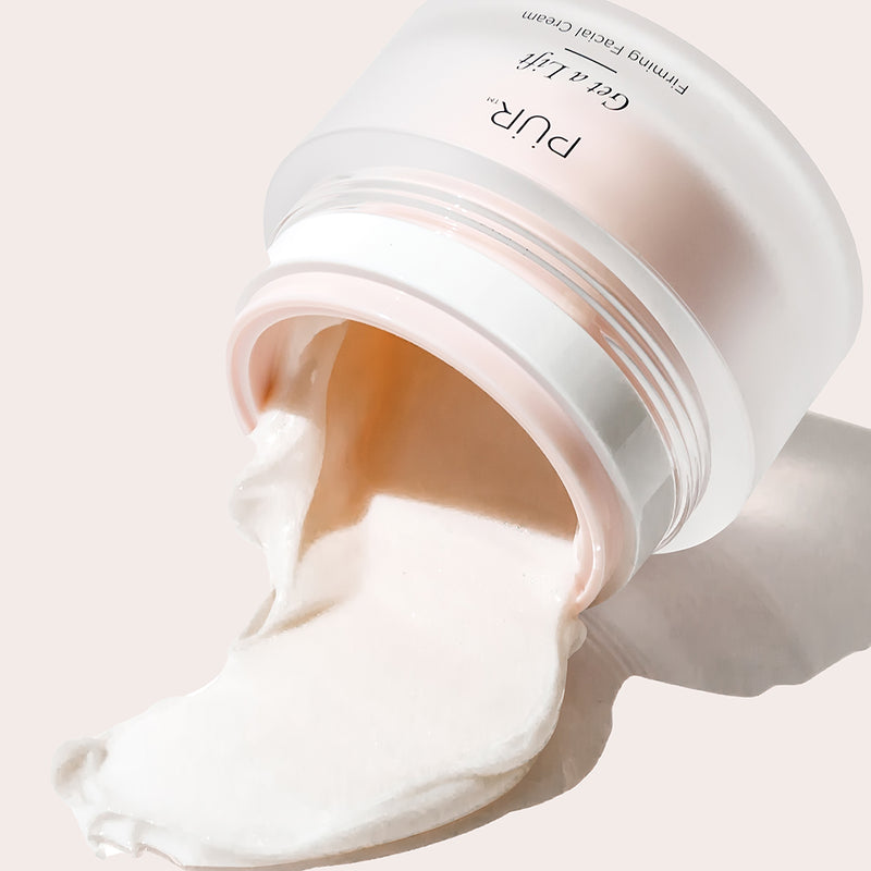 Close Up shot of Get A Lift container on side with spilled cream against off white background