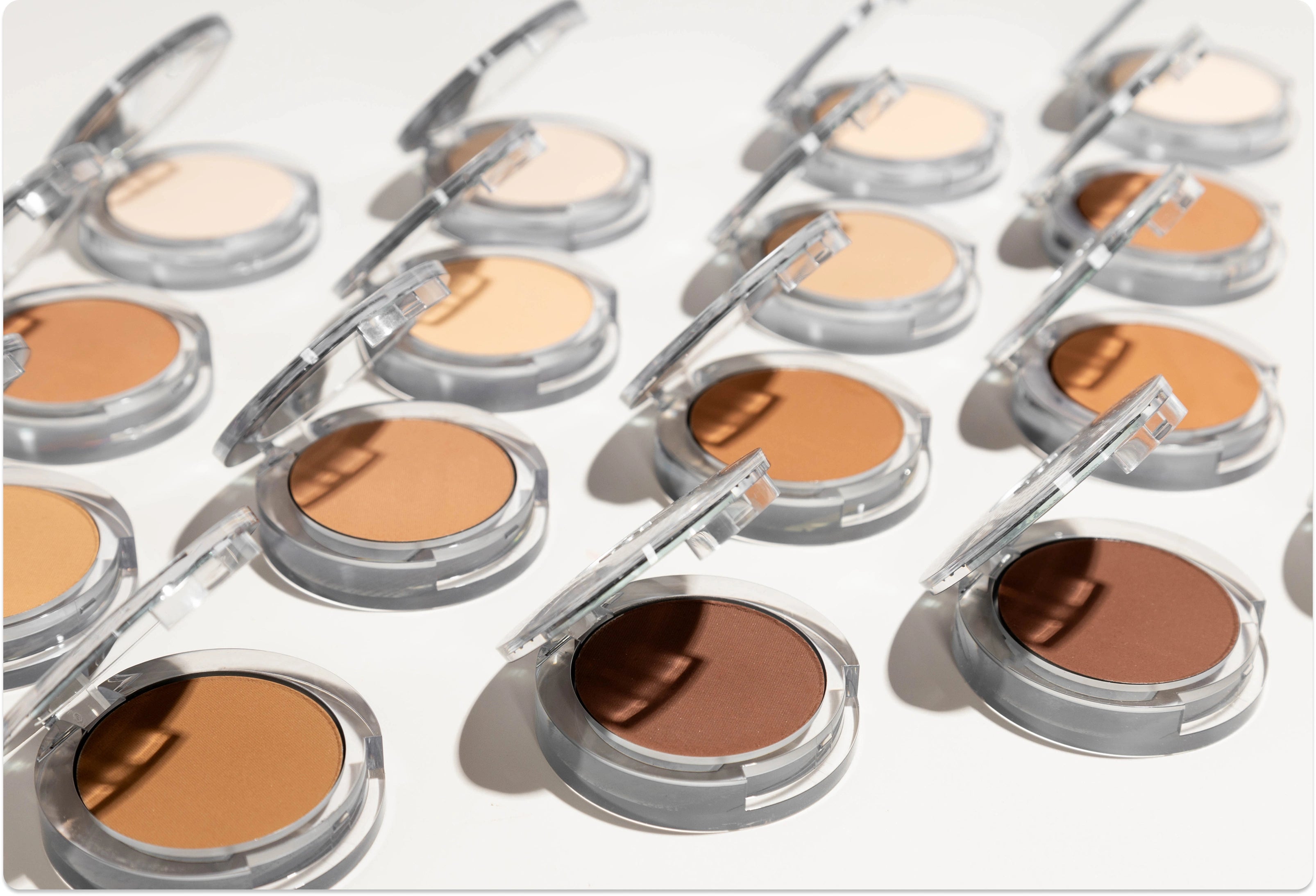 Free Mystery Bag on Orders $60+: Open Pressed Mineral Makeup in various shades lined up against white background