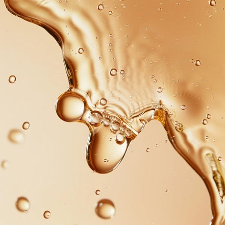 Key Ingredients - Vitamin E: Liquid serum on pink background