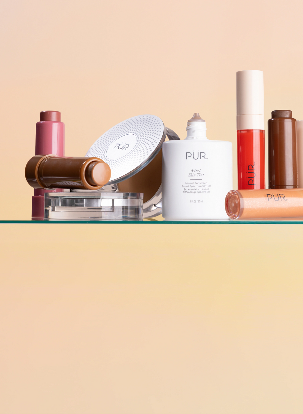Memorial Day - 30% Off Sitewide: Various PÜR makeup and complexion products stacked on glass surface against pink-to-yellow gradient background (mobile)