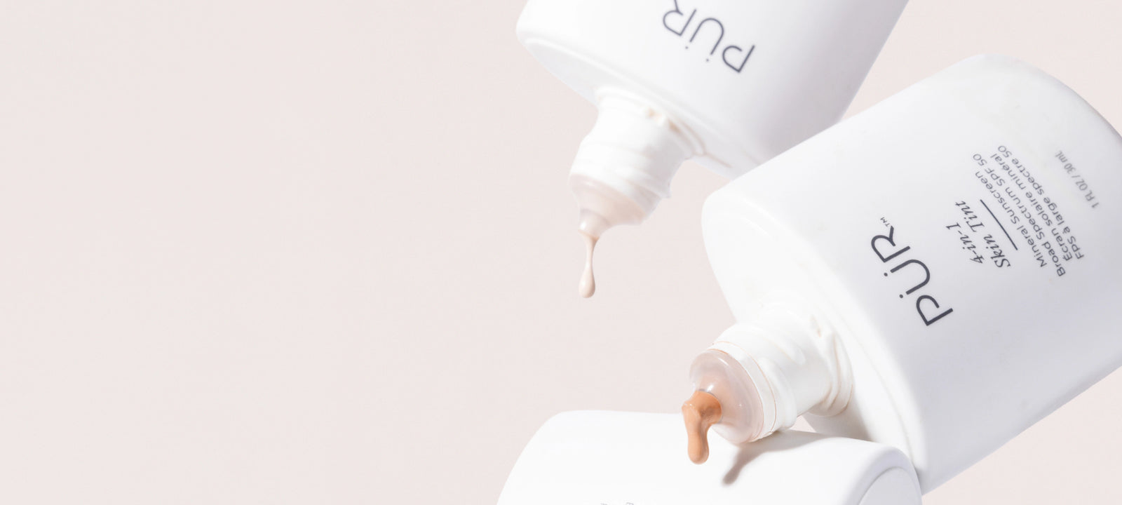 Skin Tint - Back in Stock: Two Skin Tint bottles dripping product against cream background (desktop)
