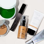 Flat-lay of PUR products including Mellow Eyes hydrogel patches, mascara, foundation, primer, and tinted moisturizer